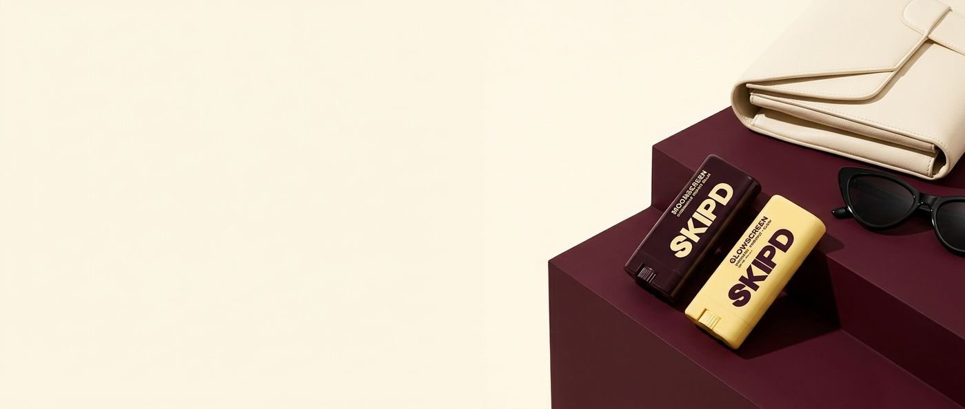 Glowscreen and Moonscreen sticks resting on a burgundy plinth beside a cream handbag